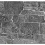 Panneau de parement mural imitation pierre naturelle, style rustique, tons de gris foncé et anthracite texturé, assemblage aléatoire de blocs rectangulaires.