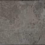Texture de pierre naturelle ou de travertin gris-brun foncé, mate et veinée, présentant des variations subtiles de tons et de petites fissures.